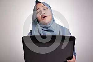 Muslim Woman Working on Laptop, Tired Sleepy Expression, Exhausted Overworked Concept