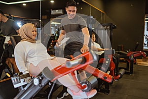 muslim woman working out with personal trainer