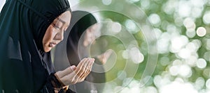 Muslim women are doing salah to pray to Allah photo