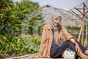 Muslim women using modern hijab sitting