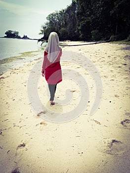 Muslim women wallking on the beach