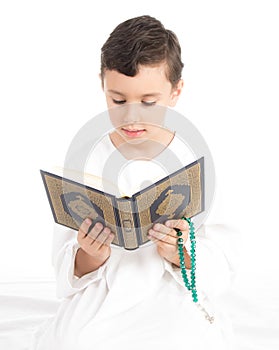 Muslim Young Boy Reading Quran And holding Rosary