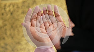 Muslim young woman in hijab is praying in mosque.