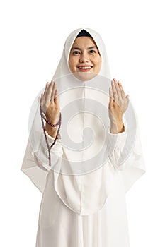 Muslim young woman praying open her arm
