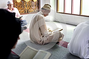 Muslims reading from the Quran