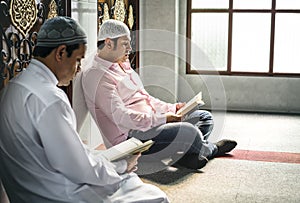 Muslims reading from the Quran photo