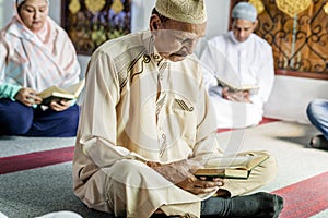 Muslims reading from the Quran