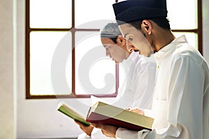 Muslims reading from the Quran photo