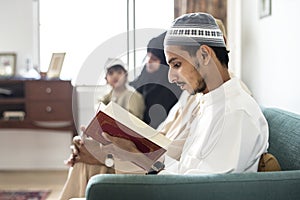 Muslims reading from the Quran at home photo