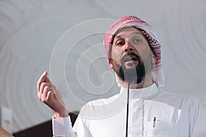 Muslims young arabic Imam has a speech on friday afternoon prayer in mosque. Muslims have gathered for the friday afternoon prayer