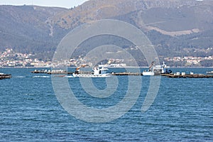 Mussel boat sailing between mussel wood platform called batea