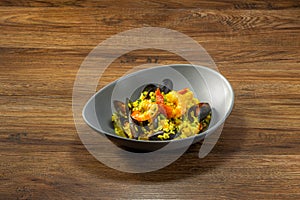 Mussel Prawn Soupy Rice served in a dish top view on dark wooden background photo