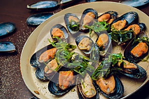 Mussels in the bowl with parsley branch.