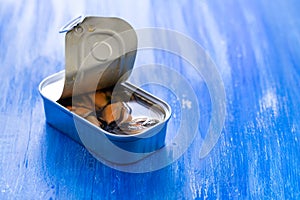 Mussels canned food on blue wooden background