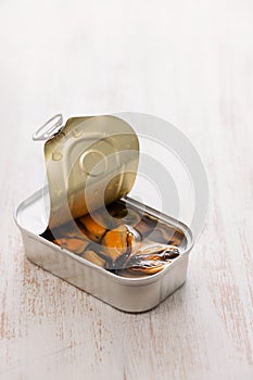 Mussels canned food on white wooden background
