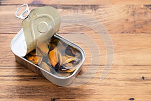 Mussels canned food on wooden background