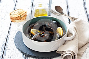 Mussels in cooper pot preparing with tymian and lemon