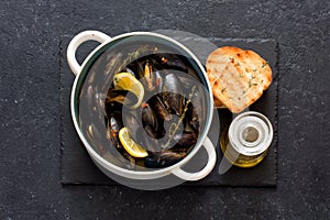 Mussels in copper pot preparing with thyme and lemon