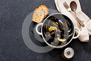 Mussels in copper pot preparing with thyme and lemon