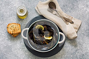 Mussels in copper pot preparing with tymian and lemon