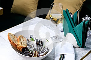 Mussels, crisp baguette and a glass of white wine. Seafood cocept. Place text