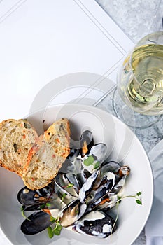 Mussels, crisp baguette and a glass of white wine. Seafood cocept. Place text