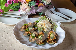 Mussels with feta cheese and spicy vegetables. Baked Mussels with Spicy Sauce. Garnished with Cherry Tomato and Salad Leaves. Spic