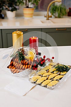 Mussels in shells and shrimps and berries and candles on kitchen table