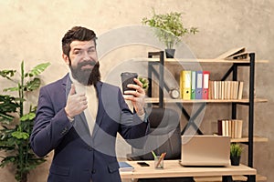 Must have stimulant for him. Man bearded manager businessman entrepreneur hold cup of coffee. Relaxed cheerful top