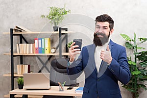 Must have stimulant for him. Man bearded manager businessman entrepreneur hold cup of coffee. Relaxed cheerful top