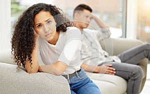 He must love. a young couple sulking after an argument at home on a sofa.