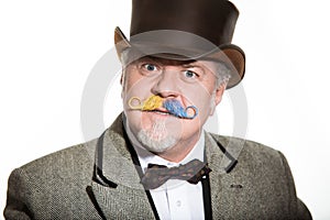 Mustache is an adult male artist in a business suit and a cylinder hat.