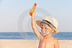 The mustache drawing sunscreen on baby (boy) face.