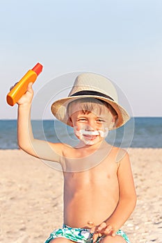 The mustache drawing sunscreen on baby (boy) face.