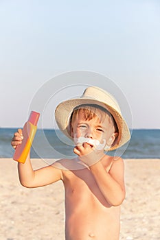 The mustache drawing sunscreen on baby (boy) face.