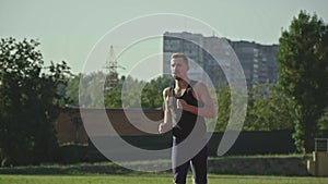 A mustachioed man in a sport suit runs to the camera and runs past, urban shooting