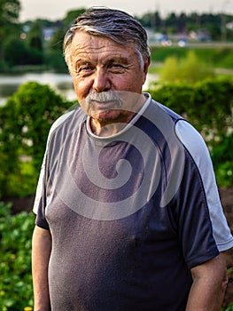 Mustachioed, unshaven old man resting in the Park