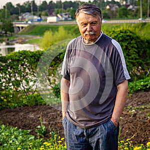 Mustachioed, unshaven old man resting in the Park