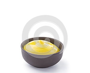 Mustard in brown bowl isolated