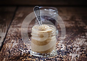 Mustard in a glass jar and seeds black and yellow mustard on an