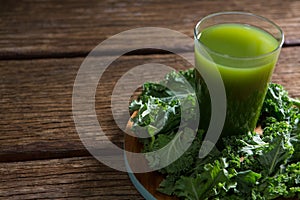 Mustard greens and juice on wooden board