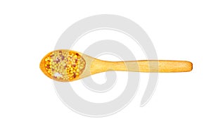 Mustard sauce in small wooden spoon isolated on white background,top view