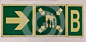 Muster station directional sign aboard ship