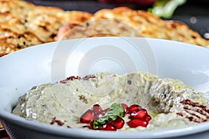 MUTABAL with pomegranate seeds served in dish close up side view of arab food