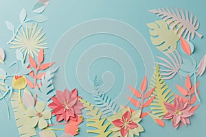 Muted color colorful flower composition - handmade papercraft flowers and leaves on pastel blue background, sprin, summer, easter