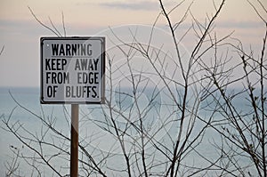 Keep away from edge sign with Muted pink sky background