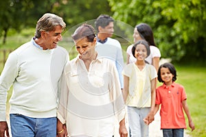 Muti-Generation Indian Family Walking In Countryside