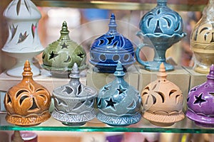 Mutrah Souq market in Old Town Muscat selling colorful porcelain Frankincense Burners souvenirs