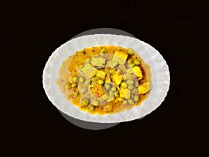 Mutter Panneer or green peas cheese cottage curry served in a plate