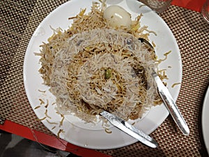 Mutton biriyani in a white plate.